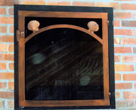 Nauset black frame, single antique copper door with scallop shells, vice grip handle and smoked glass